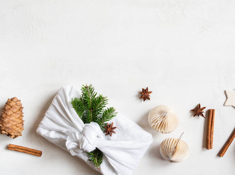 Eco-friendly Christmas table setting with reusable linen, greenery and handmade decorations